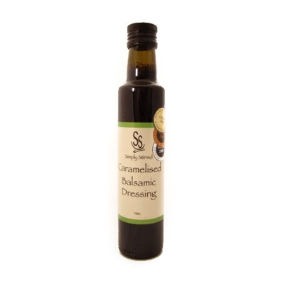 Bottle of caramelised balsamic dressing on a white background
